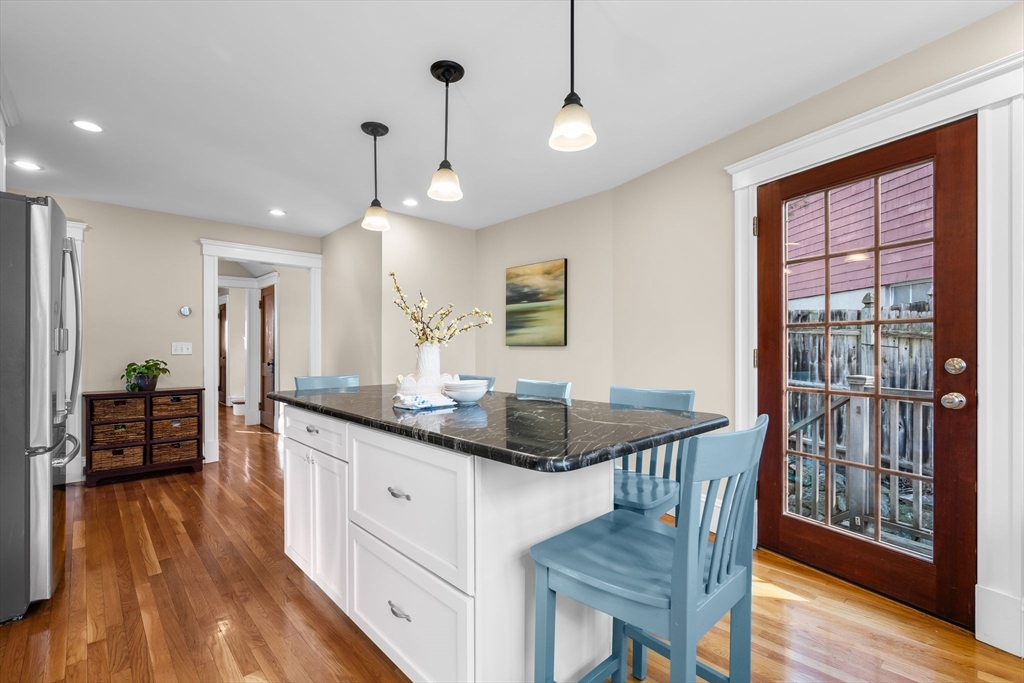 57 Edmund Road Arlington, MA 02474 - Photo 5 of 36 a kitchen with granite countertop a stove a sink a refrigerator and wooden floor