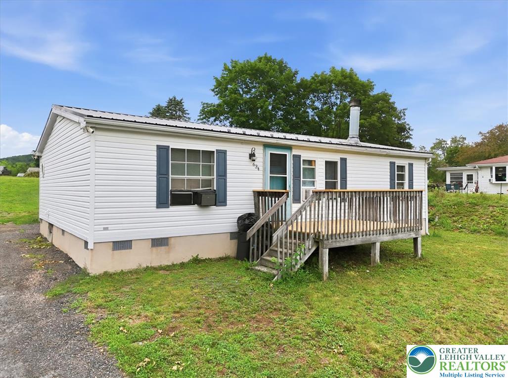 634 Main Road Lehighton, PA 18235 - Photo 2 of 39 A quaint residence featuring a front deck, perfect for enjoying peaceful rural surroundings.