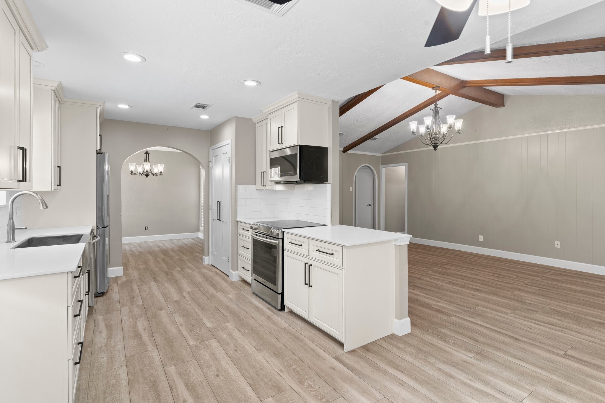 27234 Wells Lane Conroe, TX 77385 - Photo 4 of 15 a large kitchen with stainless steel appliances granite countertop a stove and a wooden floors