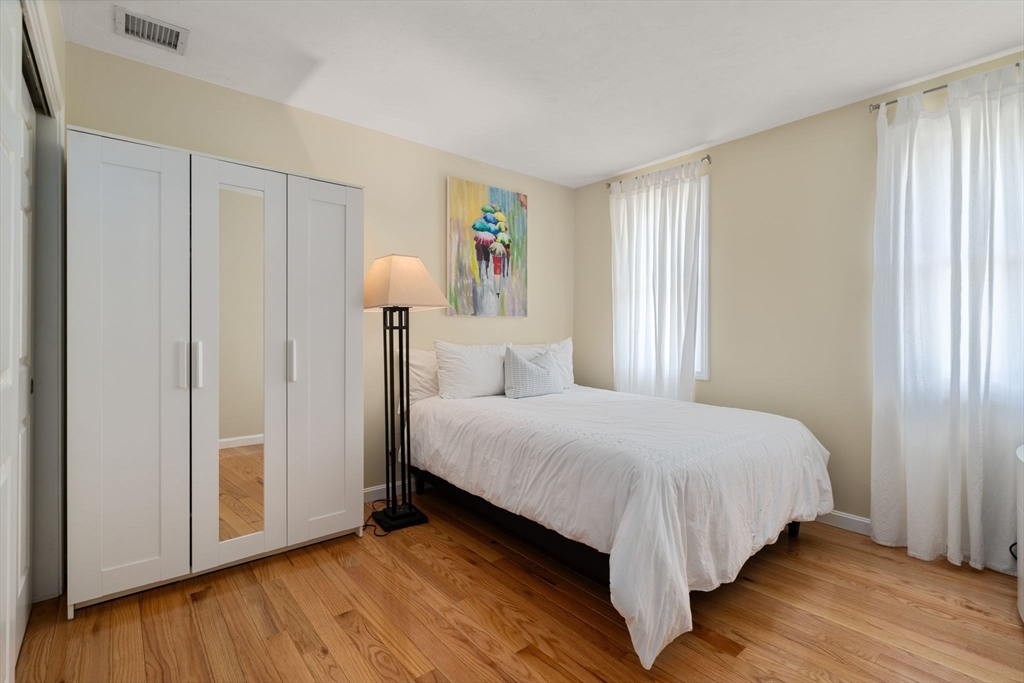 11 Cow Hill Road Sharon, MA 02067 - Photo 24 of 30 a large bed sitting in a bedroom next to a window and a lamp