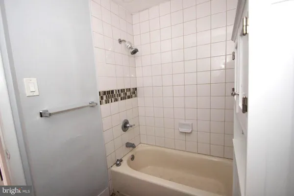 a bathroom with a bathtub and shower