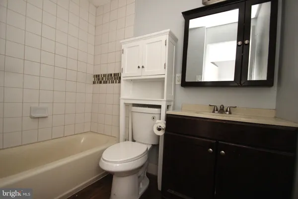 a bathroom with a sink a toilet and bathtub