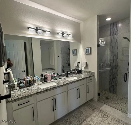 a bathroom with double sink and a mirror