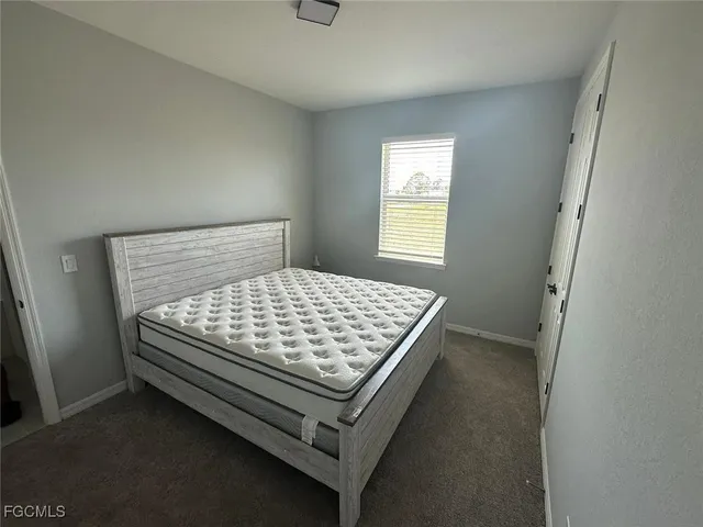 a bed sitting in a bedroom next to a window