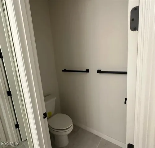 a white toilet sitting next to a shower