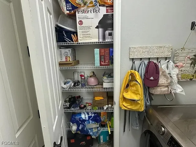 a utility room with sink dryer and washer