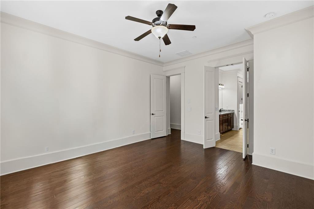 120 Walnut Circle Marietta, GA 30064 - Photo 12 of 32 an empty room with wooden floor and a ceiling fan