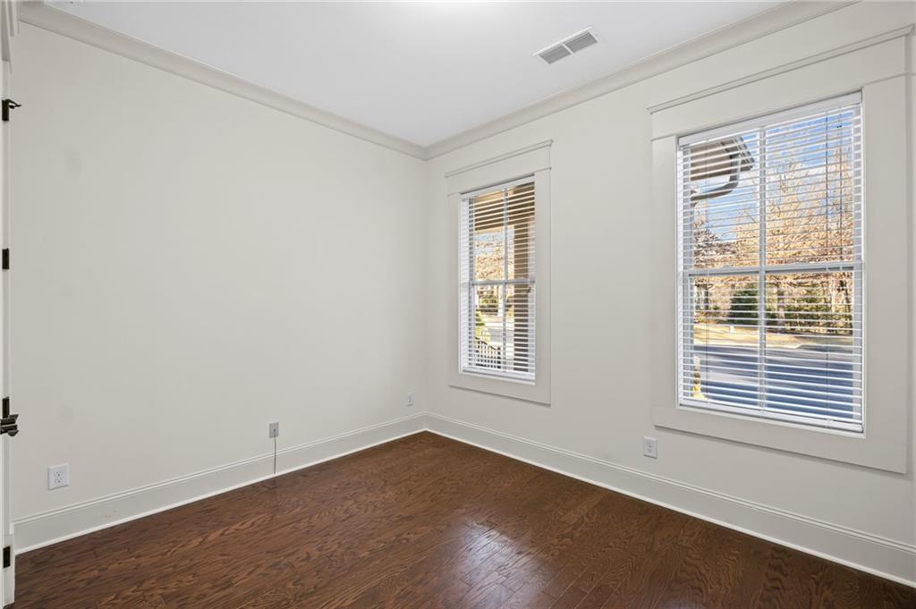 120 Walnut Circle Marietta, GA 30064 - Photo 16 of 32 a view of an empty room with wooden floor and a window