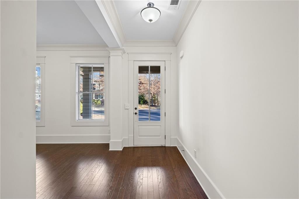 120 Walnut Circle Marietta, GA 30064 - Photo 2 of 32 an empty room with wooden floor and windows