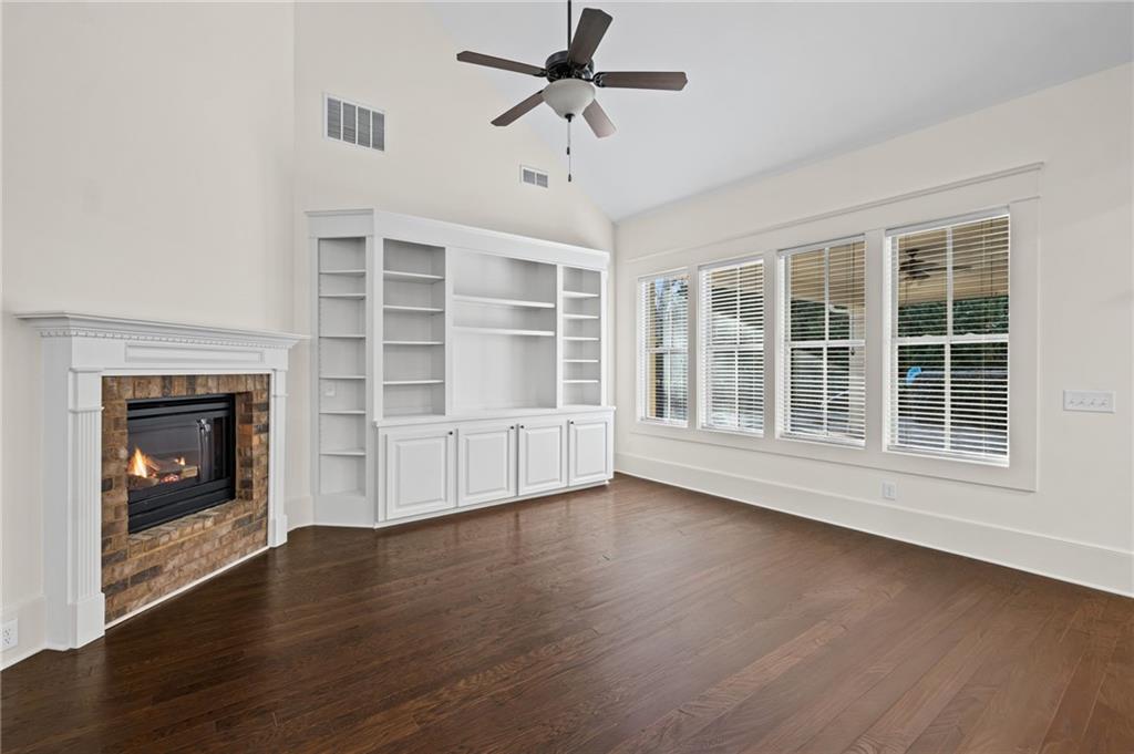120 Walnut Circle Marietta, GA 30064 - Photo 5 of 32 a view of an empty room with wooden floor fireplace and a window