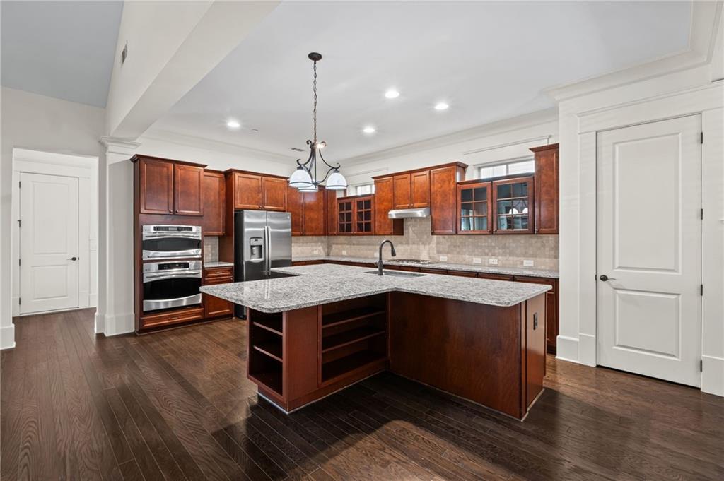 120 Walnut Circle Marietta, GA 30064 - Photo 6 of 32 a kitchen with stainless steel appliances granite countertop wooden floors and granite counter tops