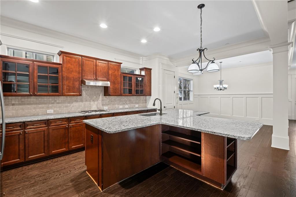 120 Walnut Circle Marietta, GA 30064 - Photo 7 of 32 a kitchen with stainless steel appliances granite countertop wooden cabinets a sink and dishwasher