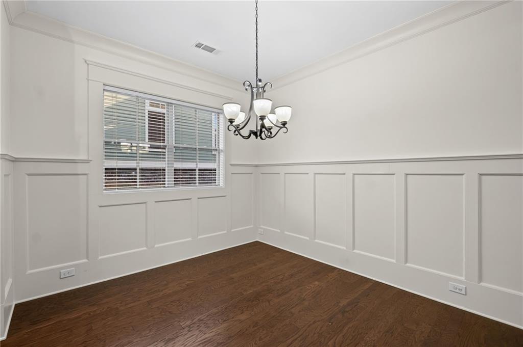 120 Walnut Circle Marietta, GA 30064 - Photo 9 of 32 a room with chandelier and wooden floor
