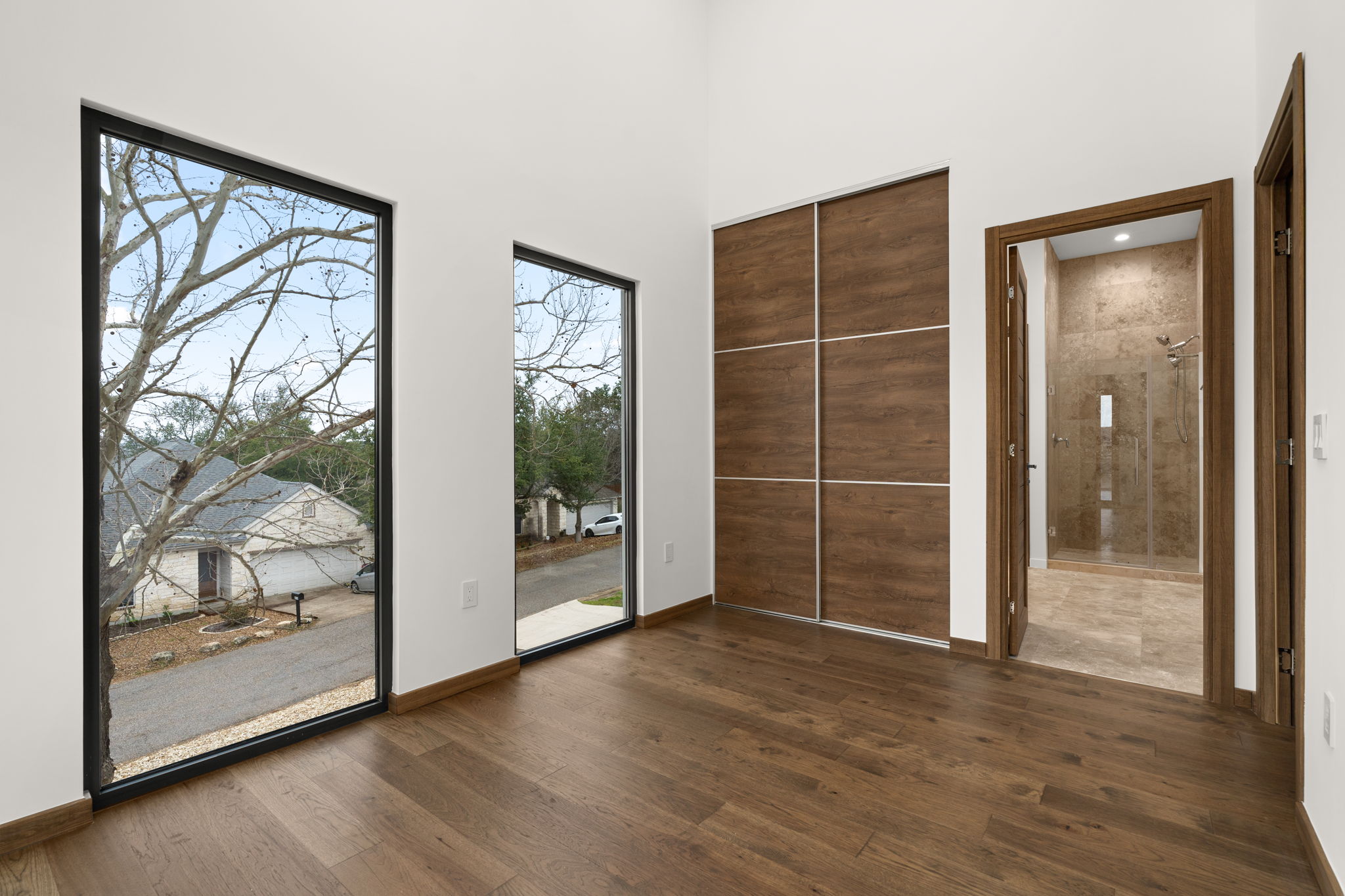 2915 Chisholm Trail Austin, TX 78734 - Photo 25 of 35 a view of an empty room with wooden floor and a window