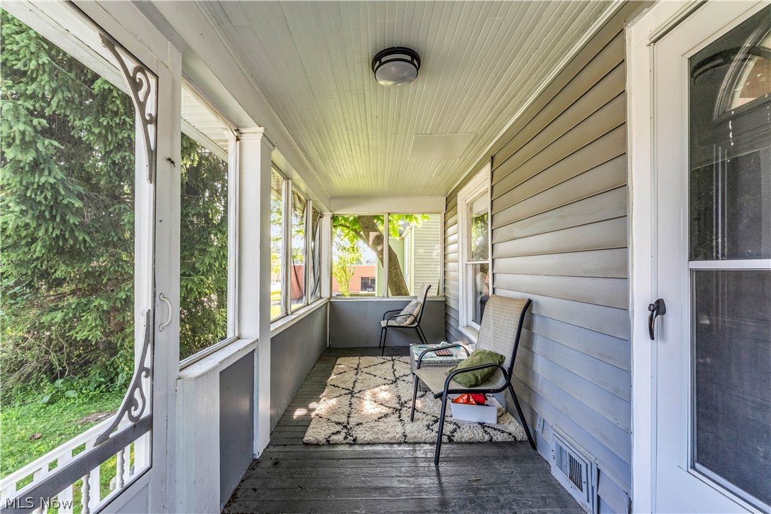 422 West Smith Road Medina, OH 44256 - Photo 4 of 29 Enclosed porch featuring wood-finish flooring, beadboard ceiling, and horizontal siding