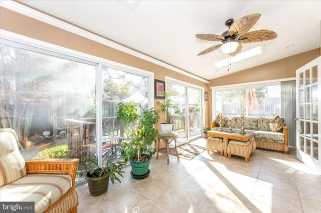 a living room with furniture a chandelier and a large window