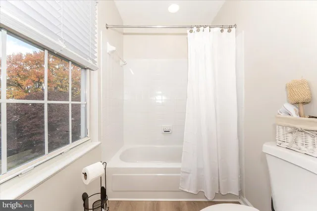 an empty room with a window and a ceiling fan