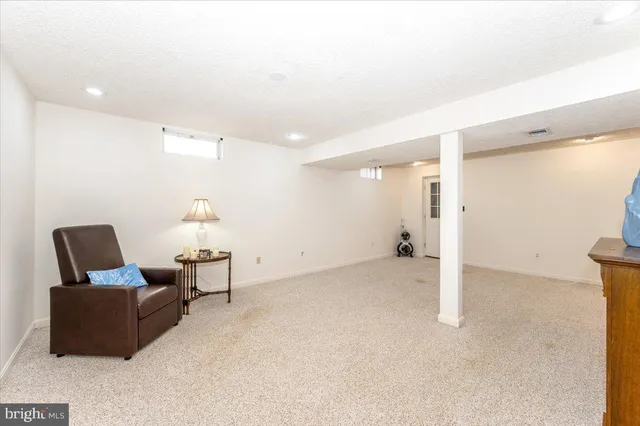a view of empty room with furniture and fireplace