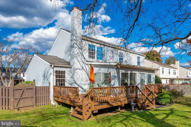 a front view of a house with a garden and plants