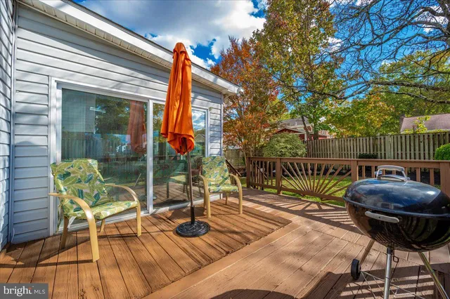 a view of balcony with wooden floor and fence