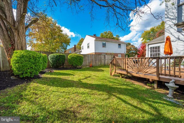 a view of a wooden deck with a big yard