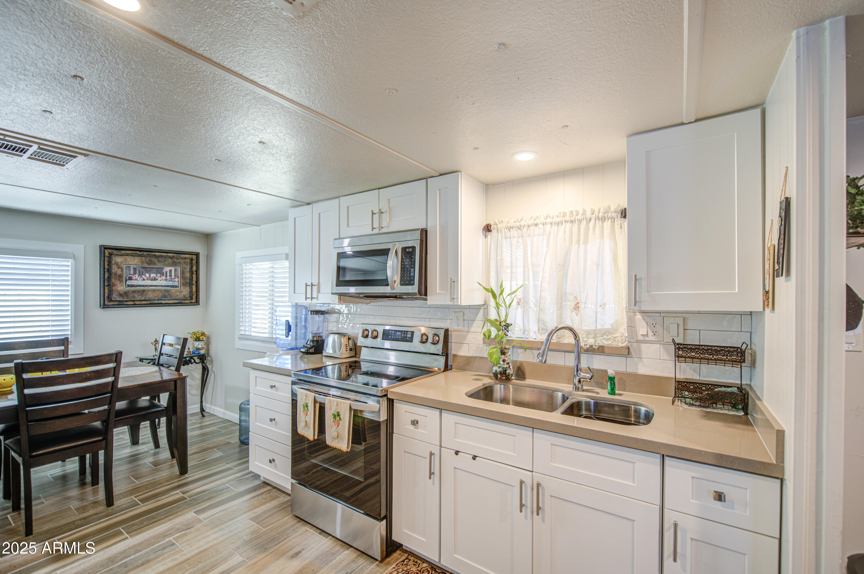 1304 East Bell Road, Unit 43 Phoenix, AZ 85022 - Photo 3 of 9 a kitchen with appliances cabinets and a counter top space
