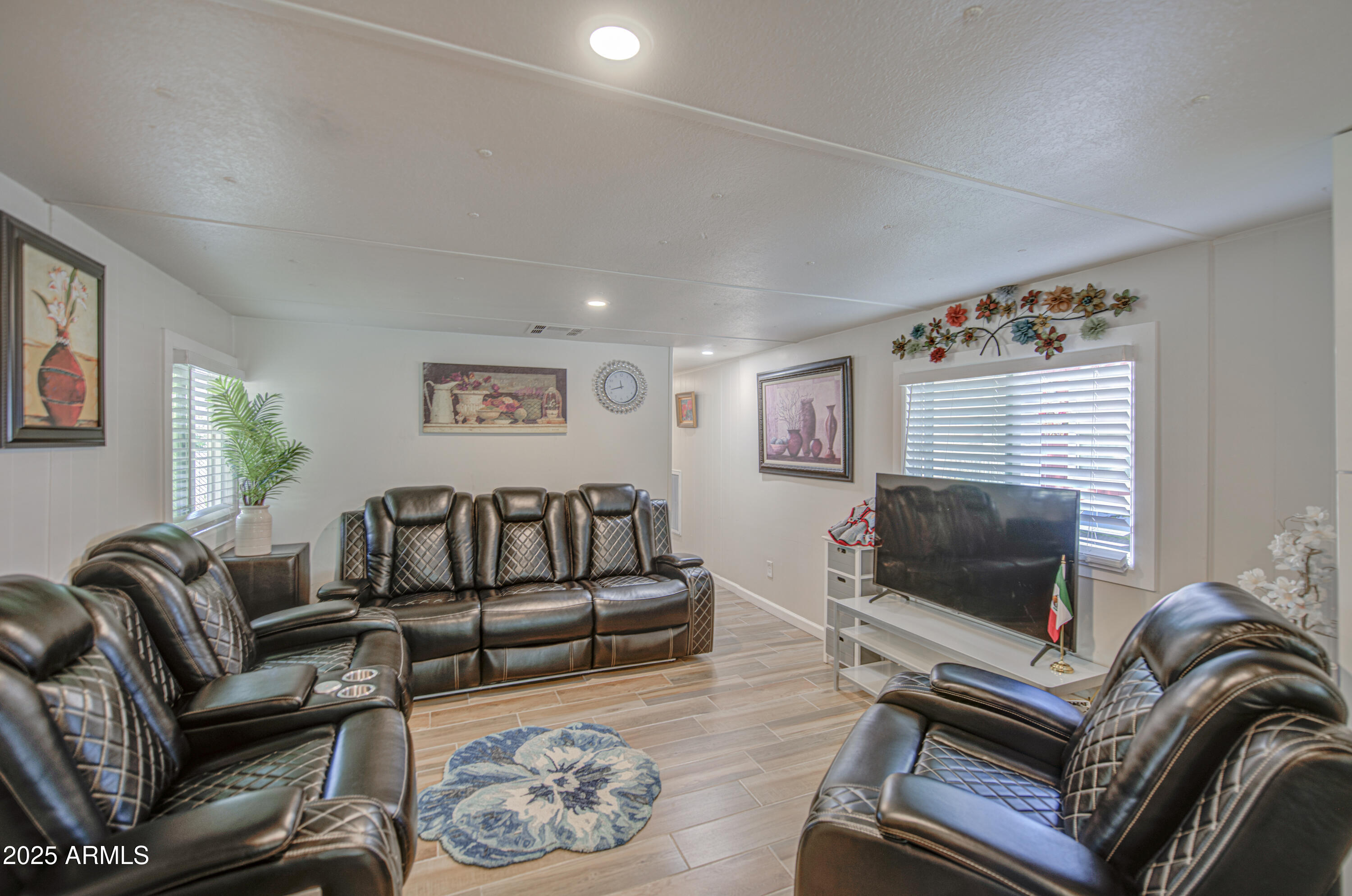 1304 East Bell Road, Unit 43 Phoenix, AZ 85022 - Photo 4 of 9 a living room with furniture and a flat screen tv