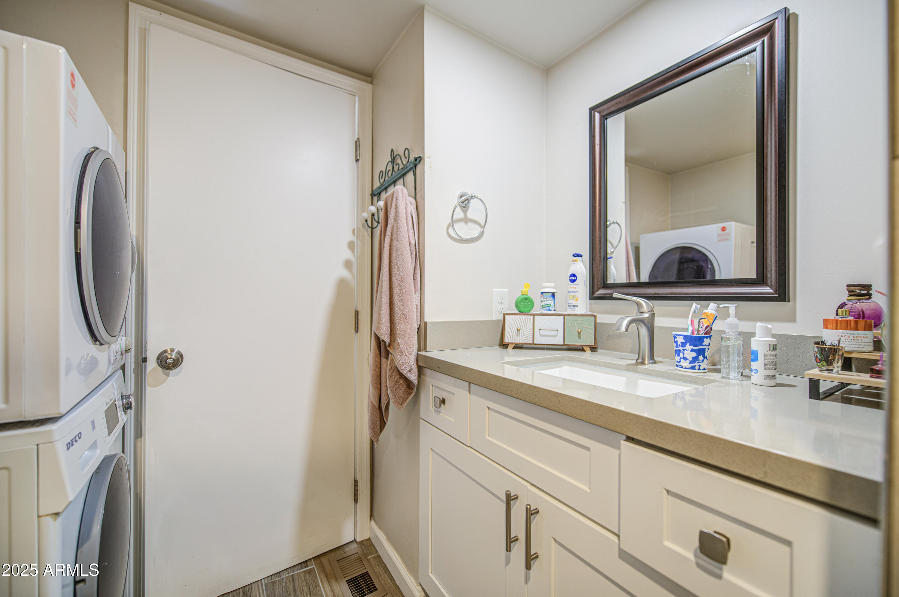 1304 East Bell Road, Unit 43 Phoenix, AZ 85022 - Photo 5 of 9 a bathroom with a sink vanity and a mirror