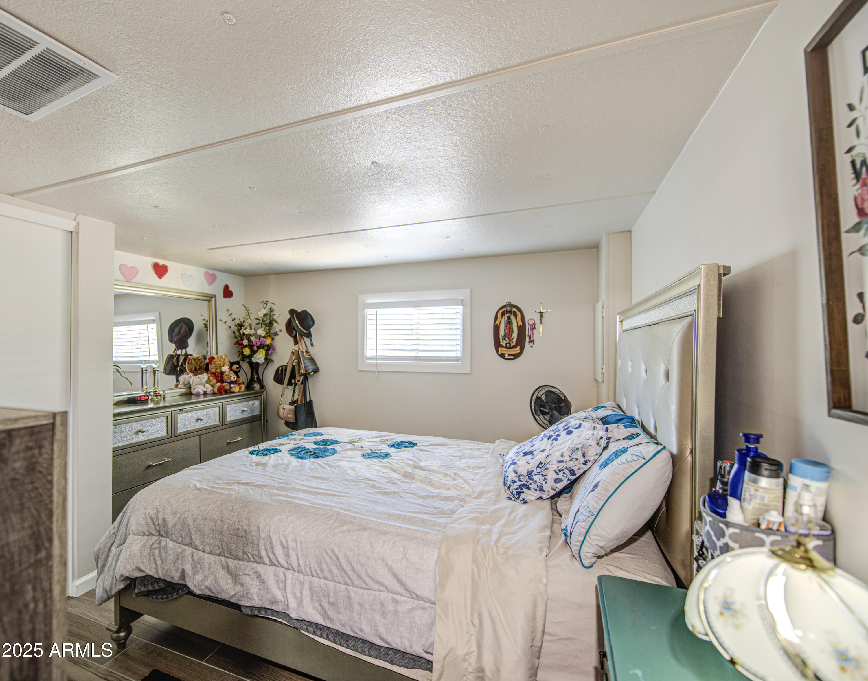 1304 East Bell Road, Unit 43 Phoenix, AZ 85022 - Photo 6 of 9 a bedroom with a bed and a large mirror with the dresser