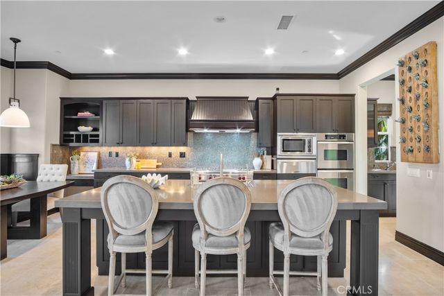 a large kitchen with a table and chairs
