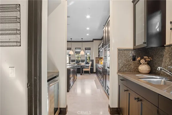 a kitchen with refrigerator and cabinets