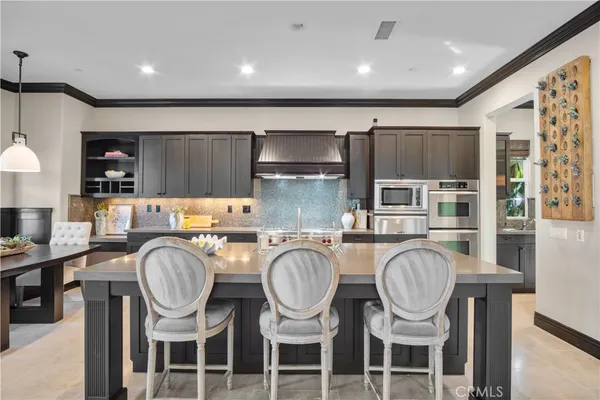 a large kitchen with a table and chairs