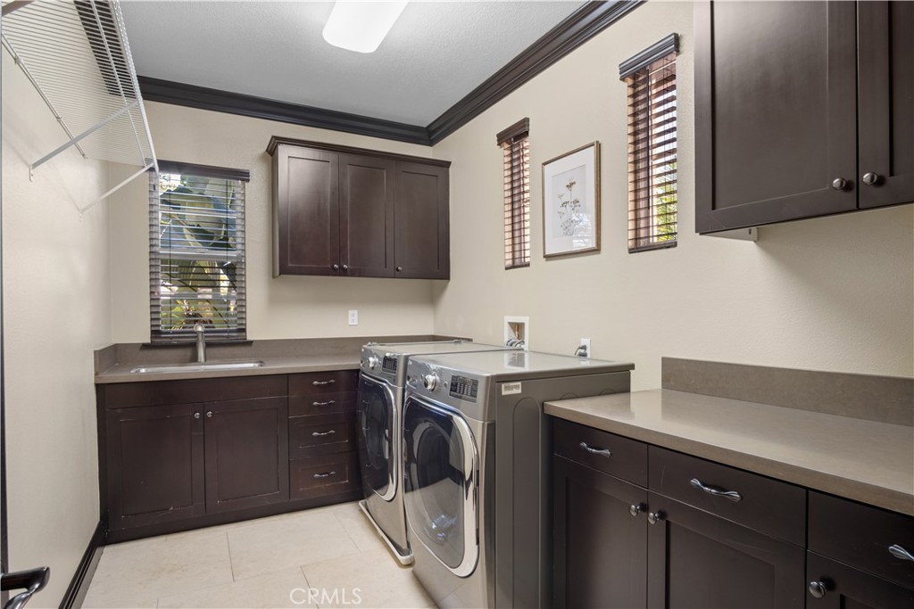 36 Via Divertirse San Clemente, CA 92673 - Photo 37 of 56 a utility room with cabinets dryer and washer