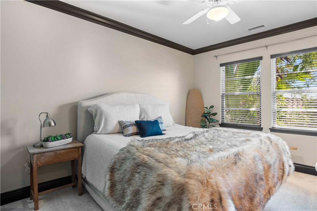 36 Via Divertirse San Clemente, CA 92673 - Photo 38 of 56 a bedroom with a bed table chair and a window