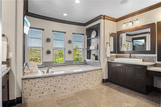 a bathroom with a granite countertop sink a toilet and shower