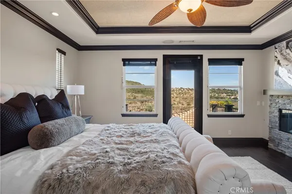 a bathroom with a granite countertop sink a toilet and a window
