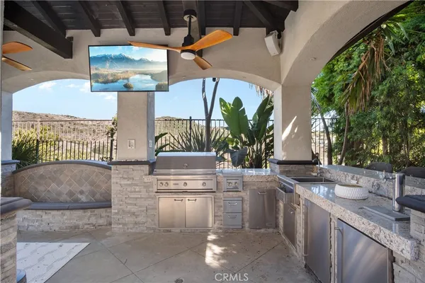 a view of outdoor kitchen with seating area