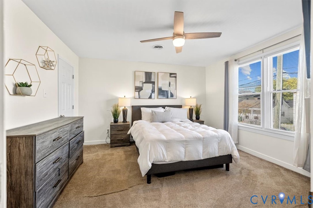 1606 Decatur Street Richmond, VA 23224 - Photo 13 of 24 a bedroom with a bed and a chandelier