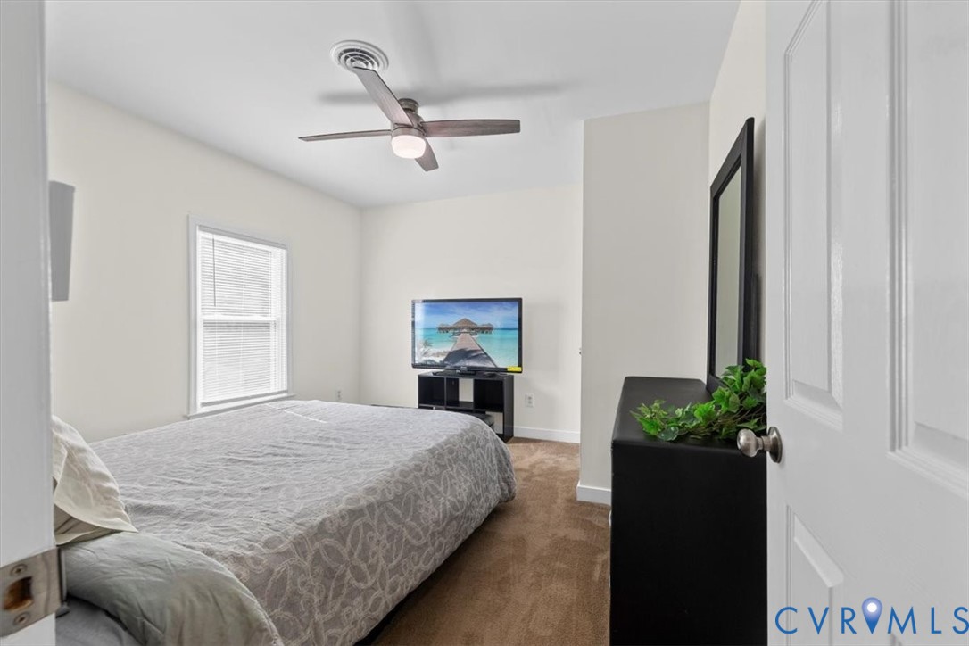 1606 Decatur Street Richmond, VA 23224 - Photo 17 of 24 a bedroom with a bed and a fireplace