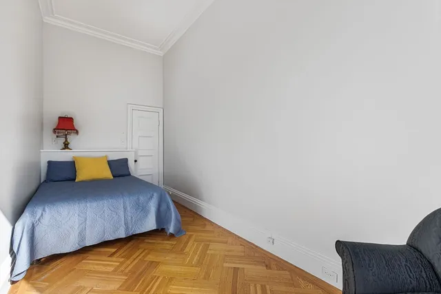 a bedroom with a bed and chair