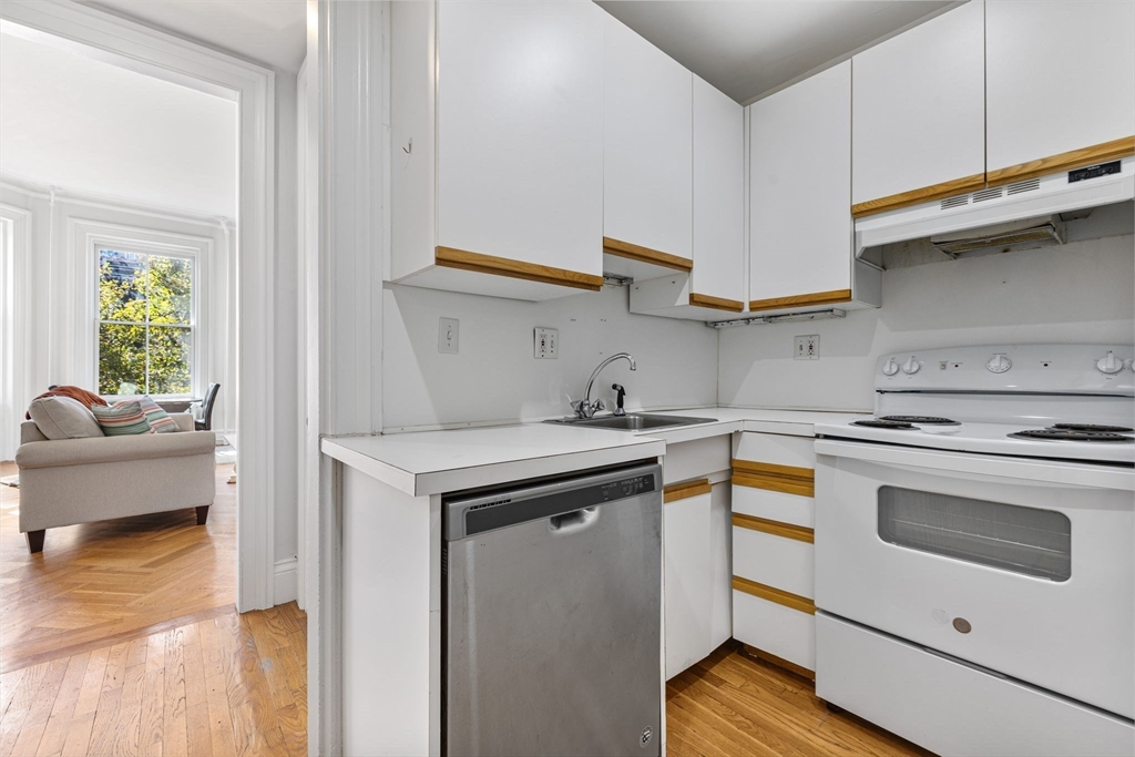 396 Beacon Street, Unit 3 Boston, MA 02116 - Photo 8 of 18 a kitchen with stainless steel appliances granite countertop a stove and a sink