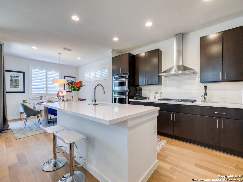133 Terrell Road, Unit 1 Alamo Heights, TX 78209 - Photo 11 of 25 a kitchen with stainless steel appliances kitchen island granite countertop a sink and cabinets