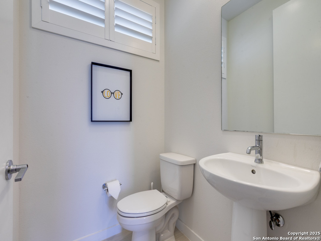 133 Terrell Road, Unit 1 Alamo Heights, TX 78209 - Photo 13 of 25 a bathroom with a toilet sink and mirror