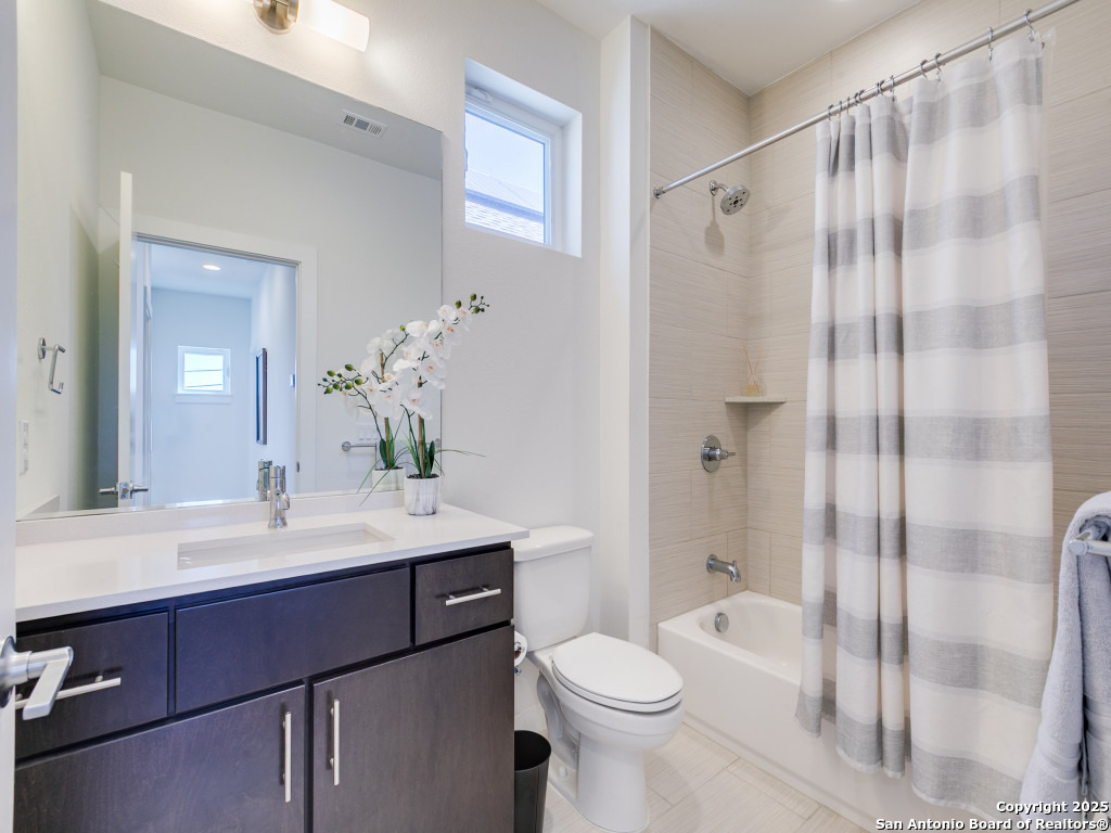 133 Terrell Road, Unit 1 Alamo Heights, TX 78209 - Photo 19 of 25 a bathroom with a sink a toilet and shower