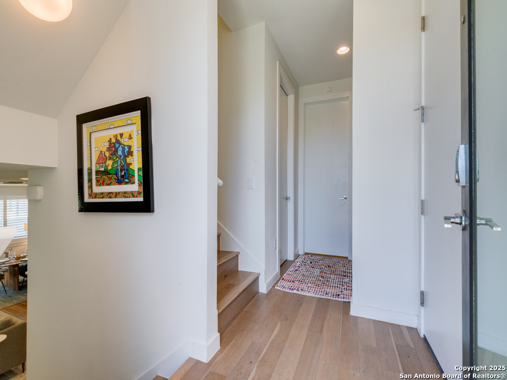 133 Terrell Road, Unit 1 Alamo Heights, TX 78209 - Photo 3 of 25 a view of a hallway with wooden floor and a bathroom