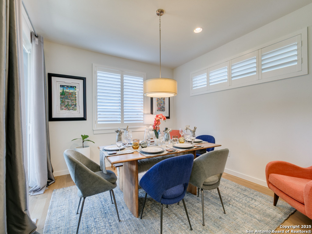 133 Terrell Road, Unit 1 Alamo Heights, TX 78209 - Photo 7 of 25 a dining room with furniture a rug and a chandelier