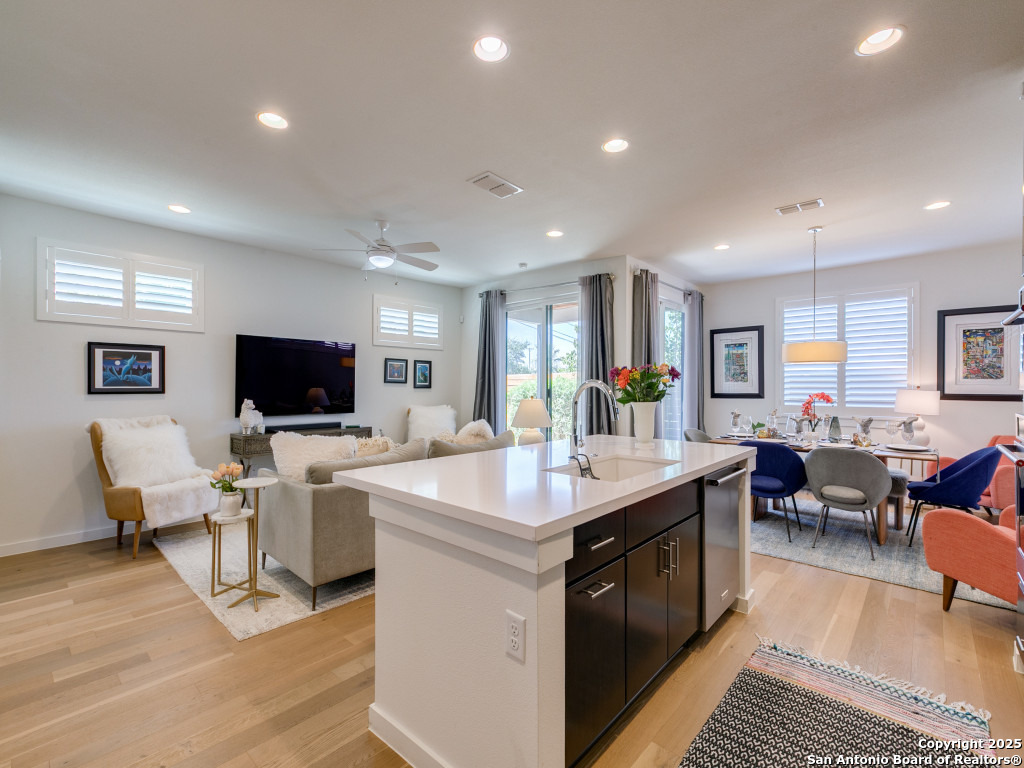 133 Terrell Road, Unit 1 Alamo Heights, TX 78209 - Photo 9 of 25 a view of living room kitchen with stainless steel appliances kitchen island granite countertop a table chairs and a couch