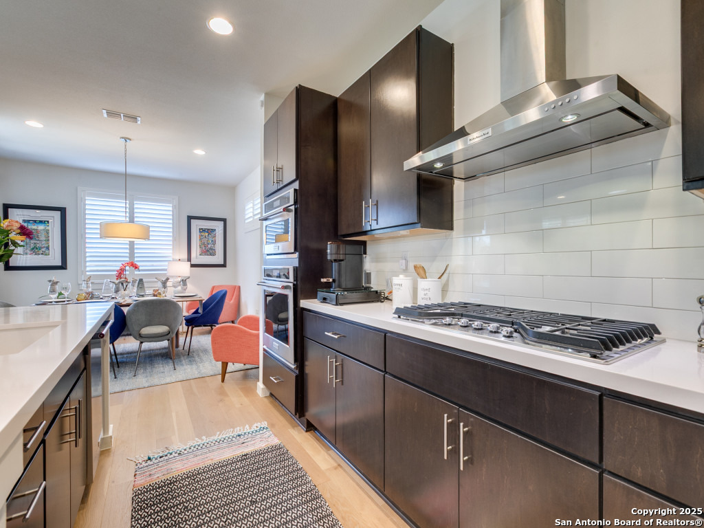 133 Terrell Road, Unit 1 Alamo Heights, TX 78209 - Photo 10 of 25 a kitchen with stainless steel appliances granite countertop a stove a sink dishwasher and cabinets with wooden floor
