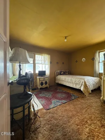 a bedroom with a bed and a chair