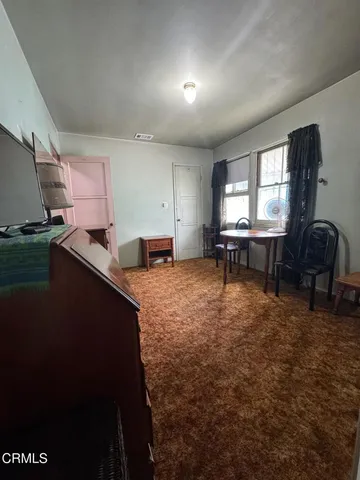 a living room with furniture and a piano